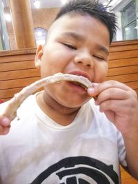 Portrait of boy eating food