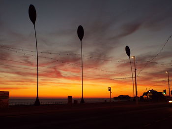 Scenic view of road against sky at sunset