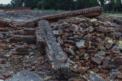 Stone wall by rocks on field