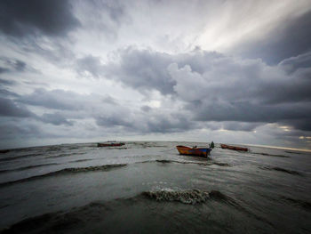 Scenic view of sea against cloudy sky