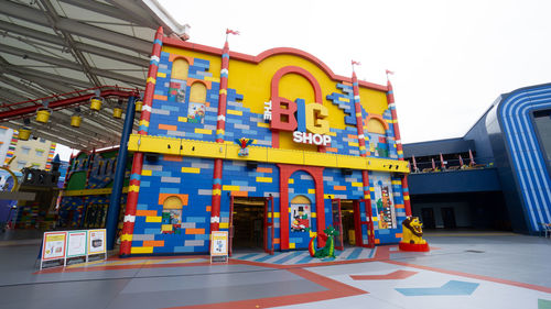 Low angle view of graffiti on building against clear sky