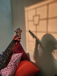 Boy playing guitar at home