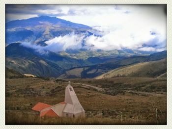 Scenic view of mountains against cloudy sky