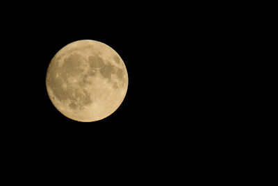 Low angle view of moon against clear sky at night