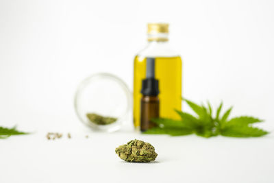 Close-up of glass bottle on table against white background