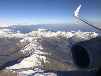 Aerial view of snowcapped mountains against sky