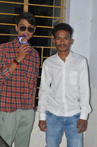 Portrait of young man wearing sunglasses standing outdoors