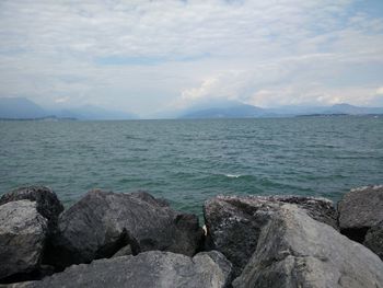 Scenic view of sea against cloudy sky