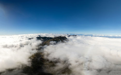 Low angle view of snowcapped mountains against sky