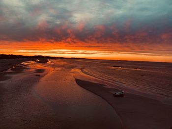 Scenic view of beach against sky during sunset