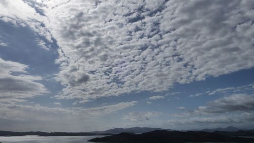 Scenic view of mountains against cloudy sky
