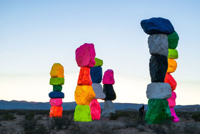 Close-up of multi colored umbrellas on beach against clear sky
