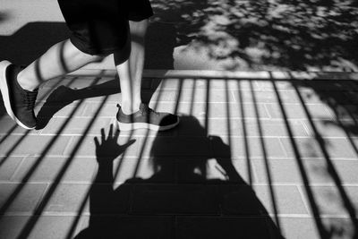 Low section of woman walking on street