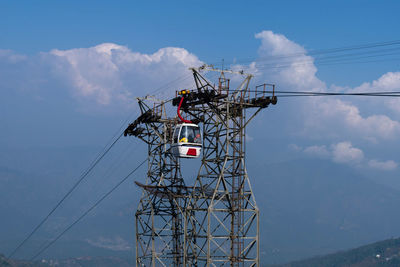 Low angle view of electricity pylon against sky