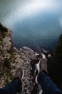 Low section of man relaxing on rock