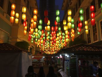 Illuminated lanterns hanging in temple at night