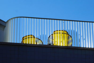 Low angle view of modern building against clear blue sky