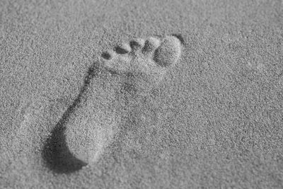 High angle view of footprints on sand