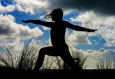 Low angle view of silhouette man against cloudy sky