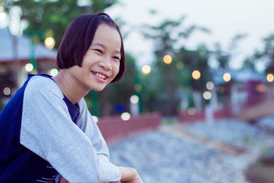 Portrait of teenage girl smiling outdoors
