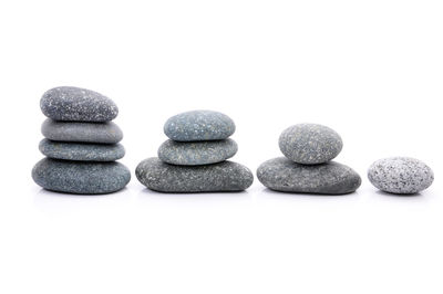 Close-up of multi colored pebbles against white background