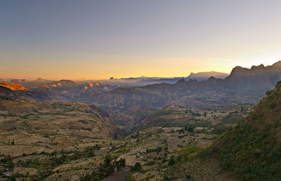 Scenic view of mountains against clear sky during sunset