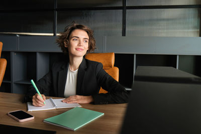 Portrait of young businesswoman working at office