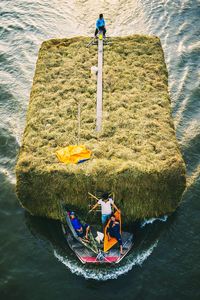 High angle view of people sitting on shore