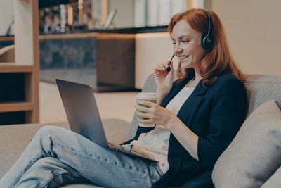 Young woman using laptop at home