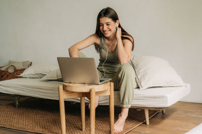 Young woman using laptop at home