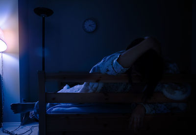 Young woman lying on bed