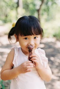 Portrait of cute girl holding outdoors
