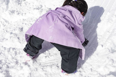 High angle view of girl on snow field