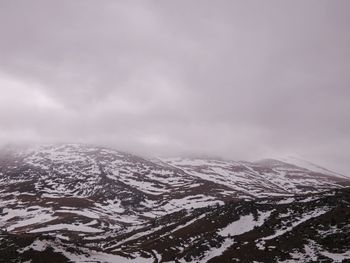 Scenic view of snow covered mountains against sky