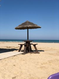 Lifeguard hut on beach against clear sky