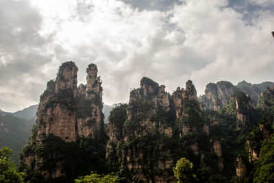 Low angle view of rock formation against sky