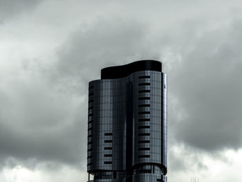 Low angle view of building against cloudy sky