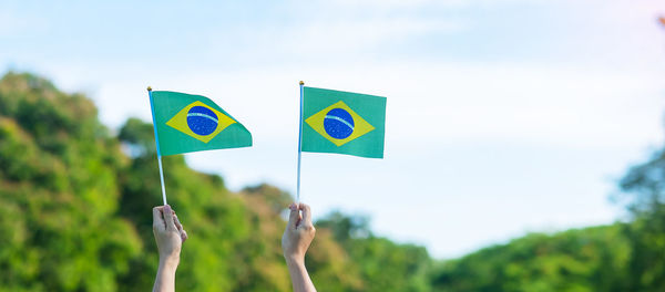 Low angle view of flag against blue sky