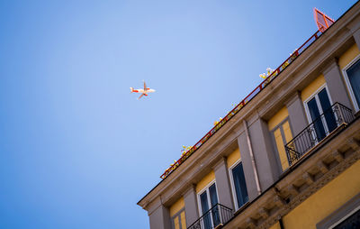 Low angle view of airplane flying against sky