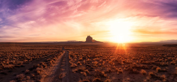 Scenic view of land against sky during sunset