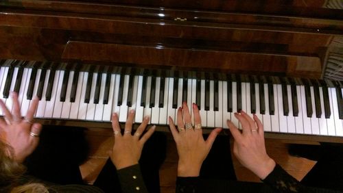 Close-up of hands playing piano