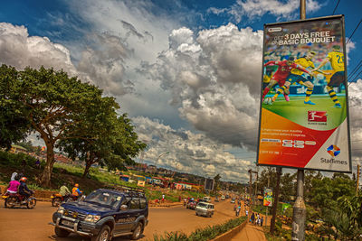 Cars on road in city against sky