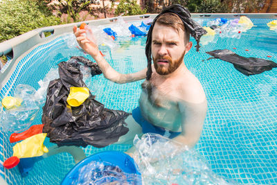 High angle view of shirtless man in swimming pool