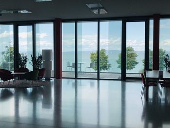 Empty chairs and table by window at home