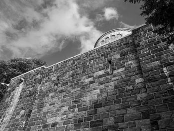 Low angle view of building against cloudy sky