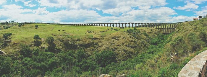 Panoramic shot of bridge over land against sky