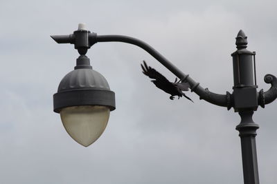 Low angle view of street light against sky