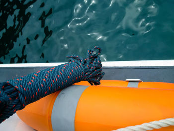 Close-up of inflatable float and rope over sea