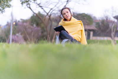 Young woman sitting on field