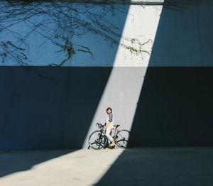 Shadow of man riding bicycle on sidewalk